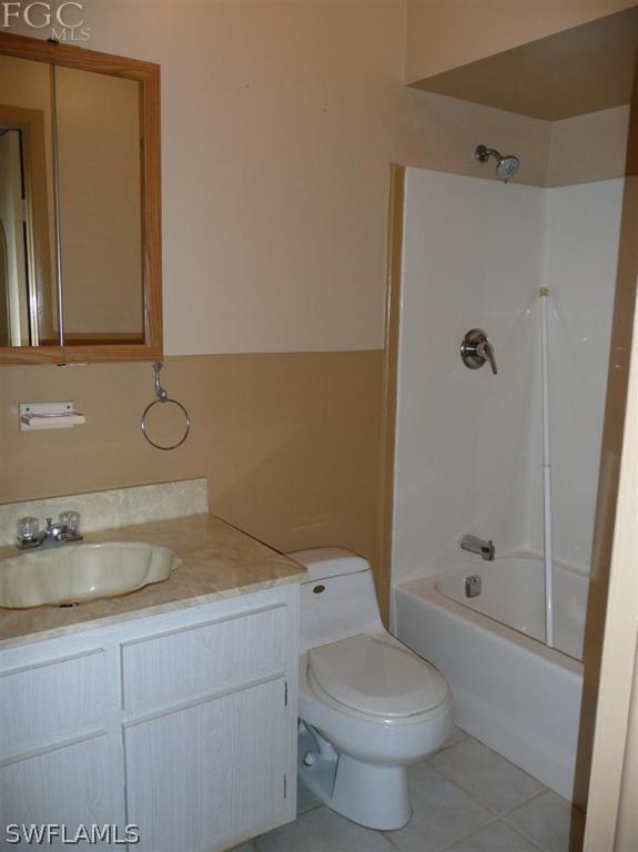 5952 Sailfish Road Bokeelia, FL 33922 - Photo 19 of 20 a bathroom with a granite countertop sink a toilet and shower