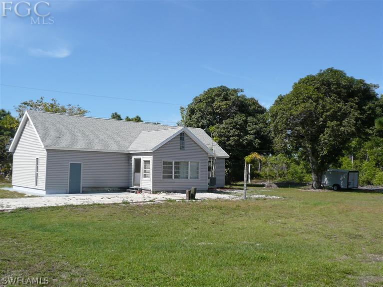 5952 Sailfish Road Bokeelia, FL 33922 - Photo 2 of 20 a front view of house with yard and green space