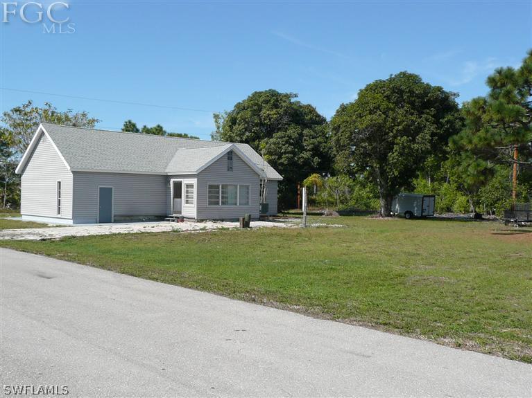 5952 Sailfish Road Bokeelia, FL 33922 - Photo 5 of 20 a front view of house with yard and green space