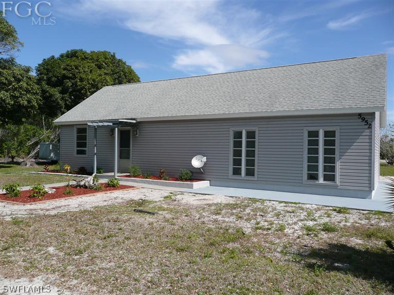5952 Sailfish Road Bokeelia, FL 33922 - Photo 6 of 20 a house with trees in the background