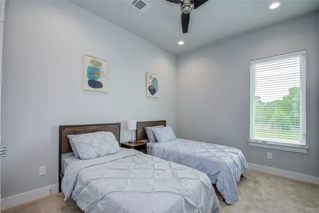 a bedroom with two beds and a window