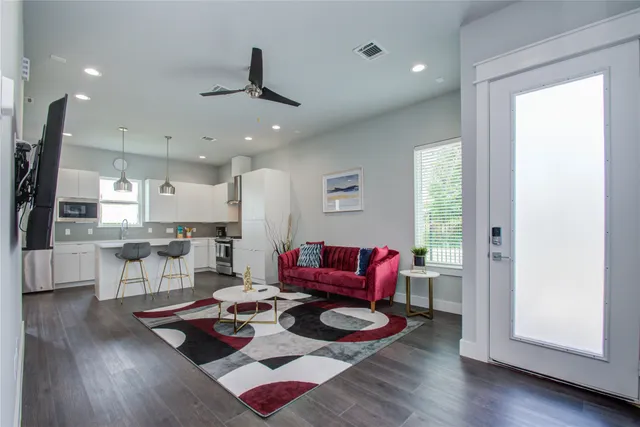 a living room with furniture and a wooden floor