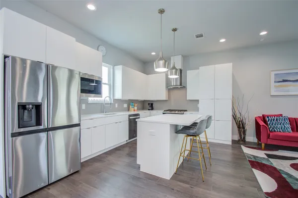 a kitchen with refrigerator microwave and stove