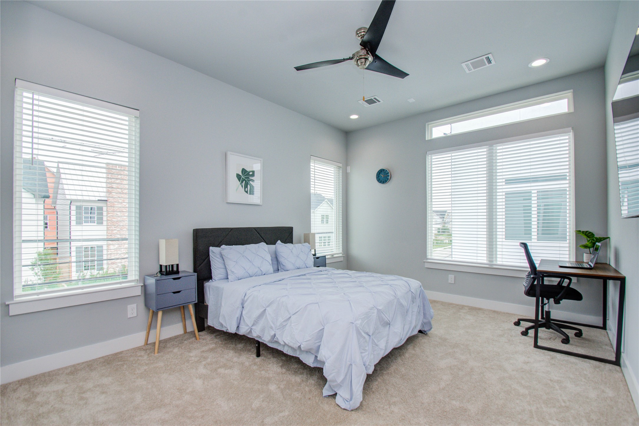 2549 Hollister Road Houston, TX 77080 - Photo 9 of 16 a spacious bedroom with a bed a table and windows