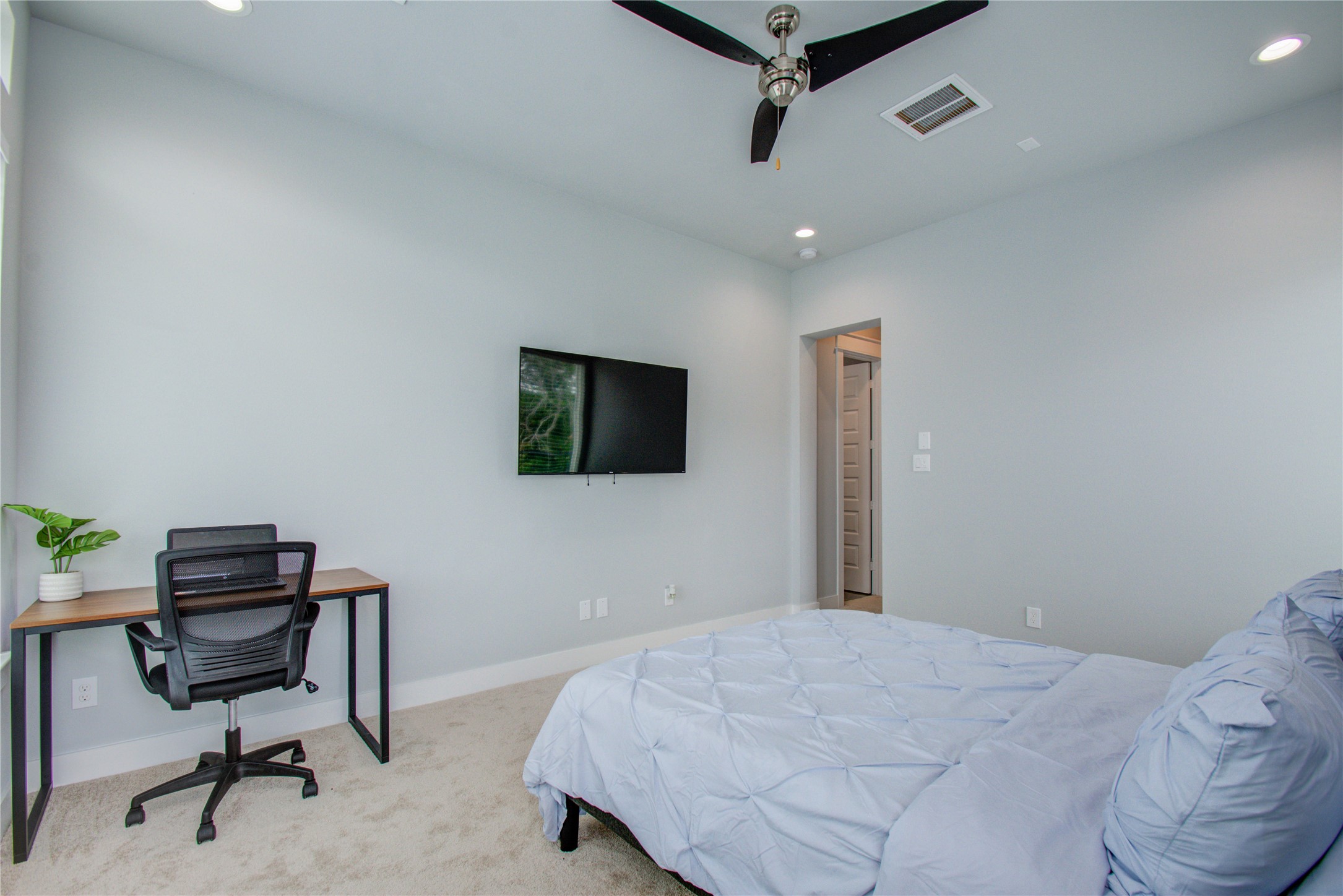 2549 Hollister Road Houston, TX 77080 - Photo 10 of 16 a bedroom with a bed a desk and chair
