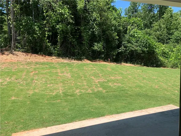 a view of yard with swimming pool and trees