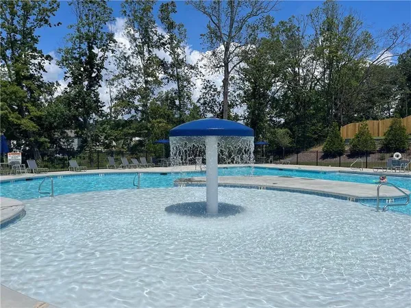 a swimming pool with outdoor seating and yard