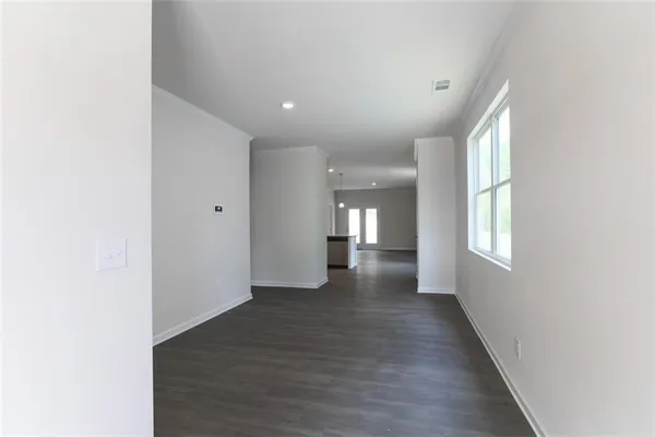 a view of a hallway with wooden floor and staircase