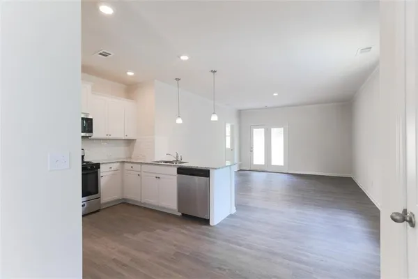 a open kitchen with a sink and stove top oven