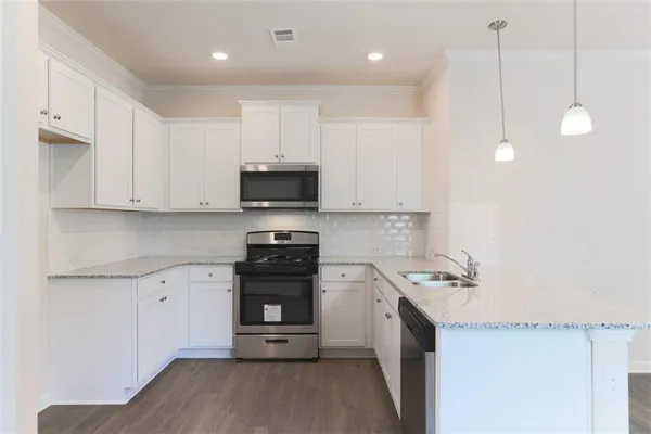 a kitchen with a sink a stove and cabinets