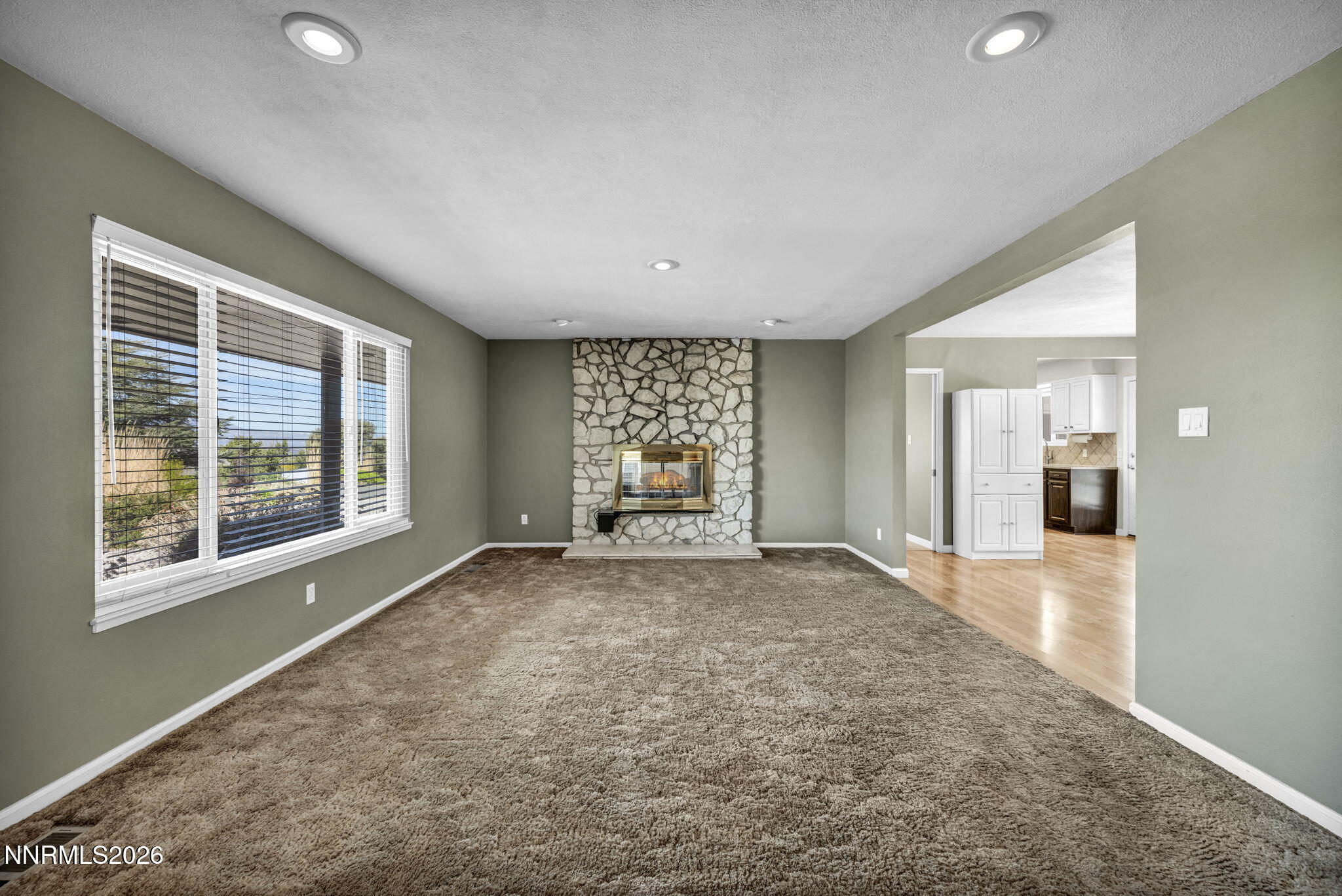 14190 Rim Rock Drive Reno, NV 89521 - Photo 8 of 68 a view of a big room with windows and chandelier fan