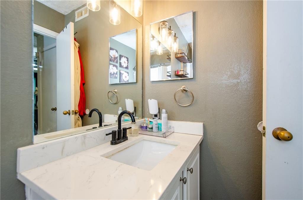 5157 Roswell Road, Unit 2 Atlanta, GA 30342 - Photo 21 of 24 a bathroom with a sink vanity and a mirror