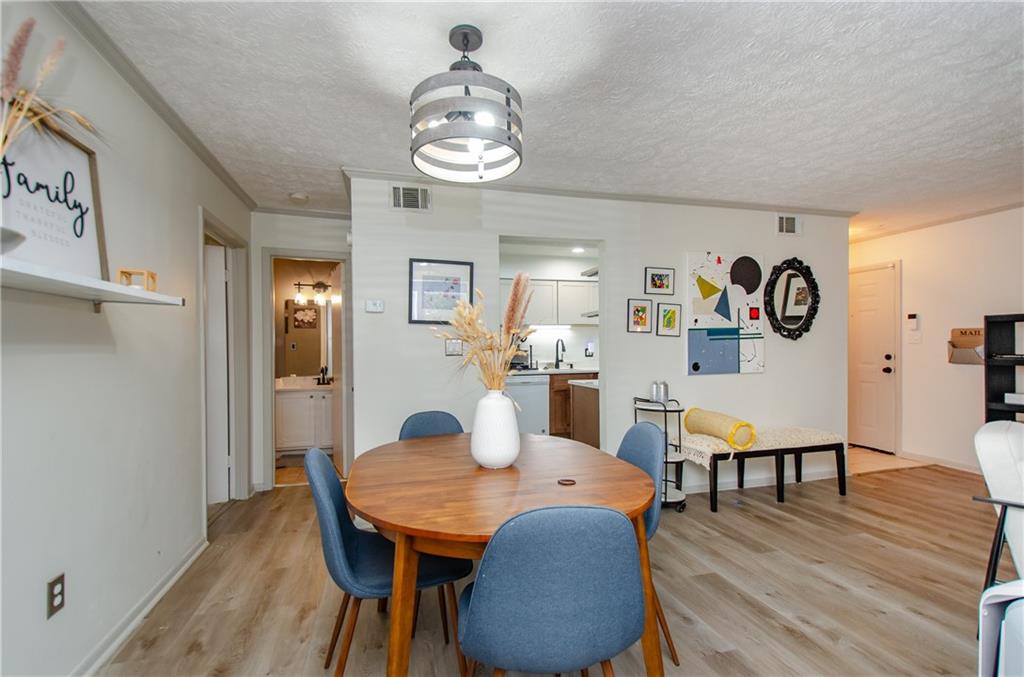 5157 Roswell Road, Unit 2 Atlanta, GA 30342 - Photo 9 of 24 a view of a dining room with furniture and wooden floor