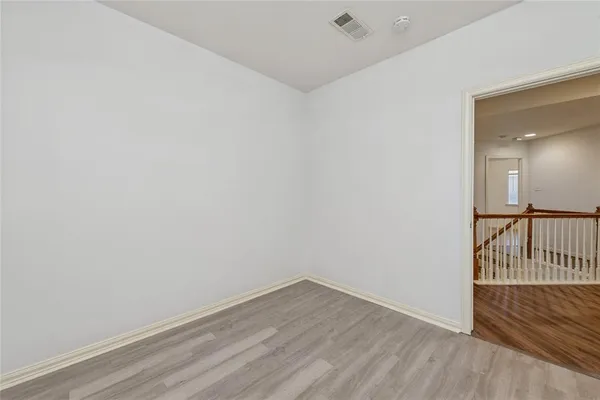 a view of a room with wooden floor