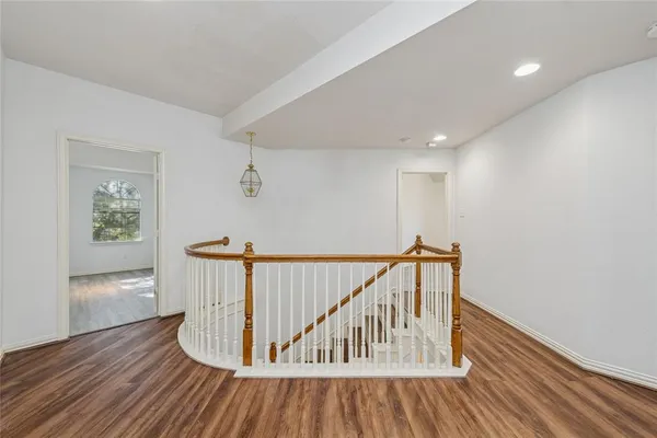 a view of staircase with wooden floor and a rug