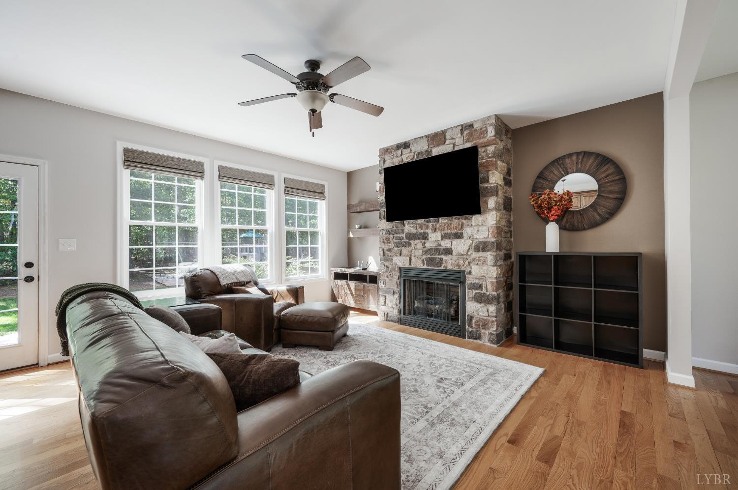 333 Sunset Ridge Drive Concord, VA 24538 - Photo 18 of 61 a living room with furniture a fireplace and a flat screen tv