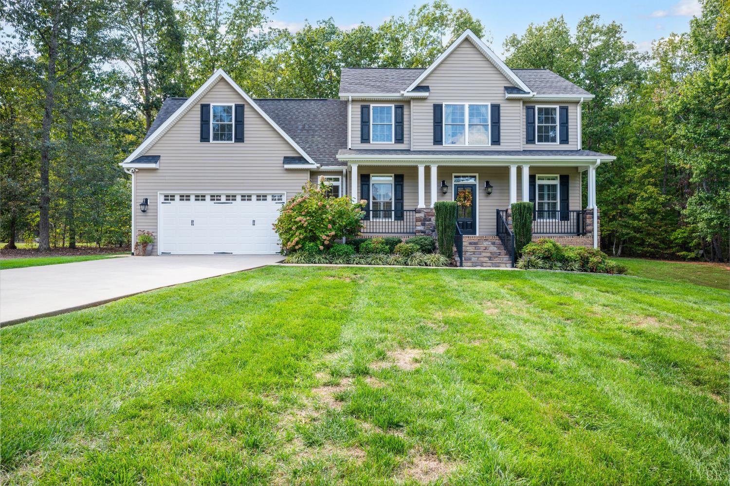 333 Sunset Ridge Drive Concord, VA 24538 - Photo 2 of 61 a front view of a house with garden and porch