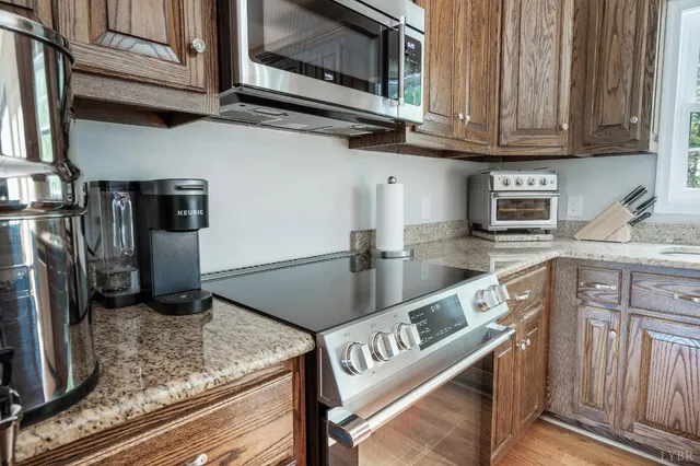 a kitchen with granite countertop a sink and a window