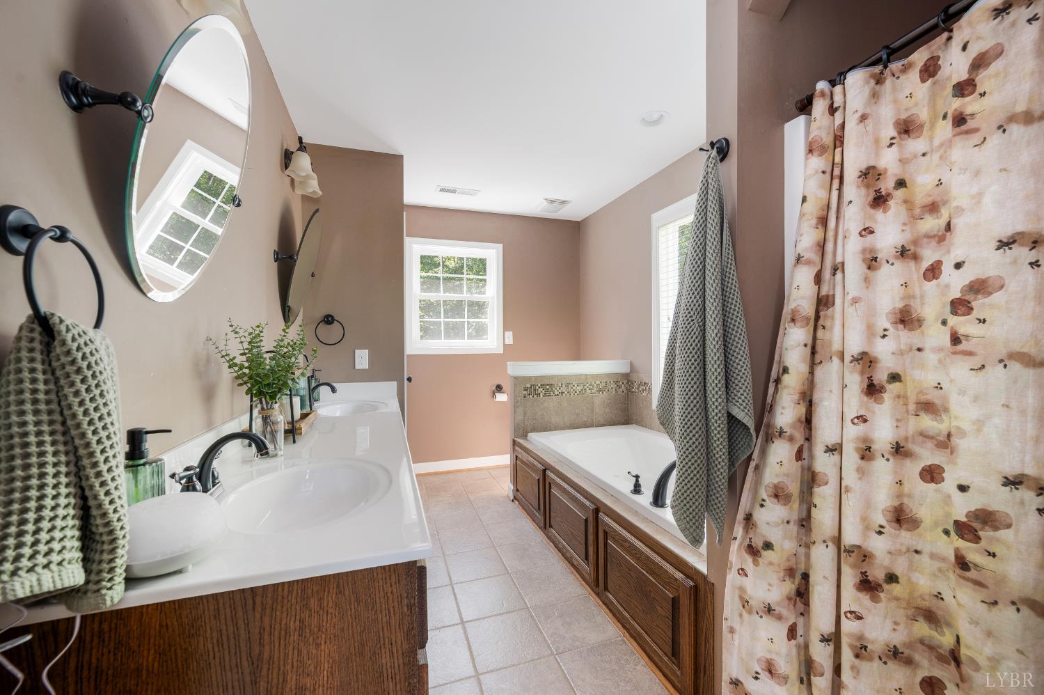 333 Sunset Ridge Drive Concord, VA 24538 - Photo 33 of 61 a large white bathroom with a granite countertop sink a mirror a potted plant and a window