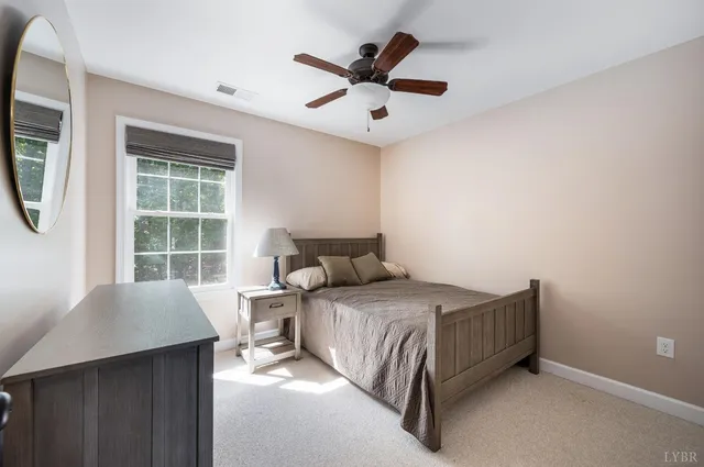 a view of a livingroom with furniture a ceiling fan and window