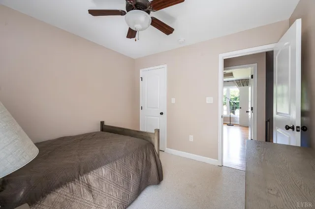 a front view of a house with garden and trees