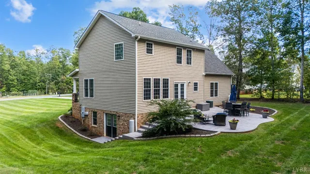 a view of a house with a yard porch and sitting area