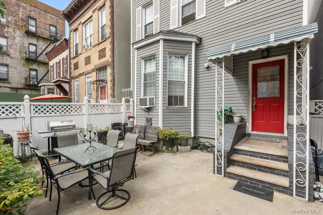 a view of a patio with table and chairs and potted plants