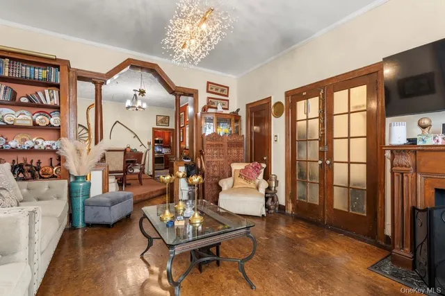 a living room with furniture a floor to ceiling window and a flat screen tv