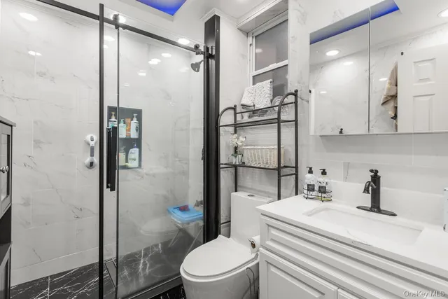 a bathroom with a sink a toilet and shower