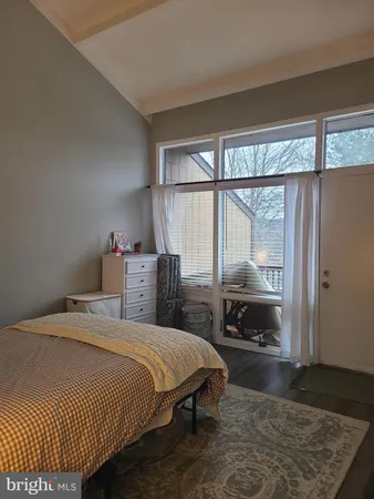 a bedroom with a bed a table and chair