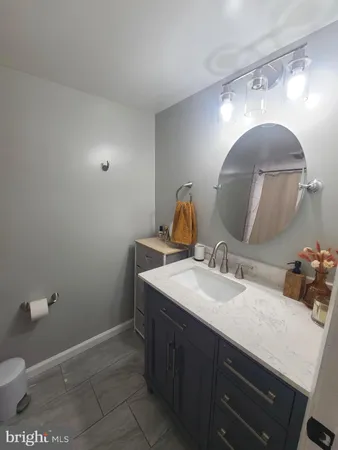 a bathroom with a sink vanity and a mirror