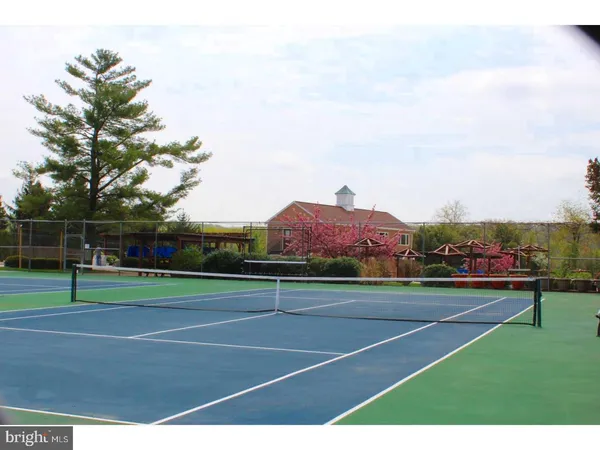 a basketball court with view of buildings in the background