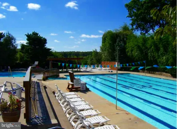 a view of swimming pool with chairs