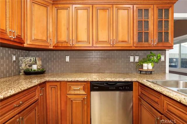 a kitchen with granite countertop stainless steel appliances granite countertop a sink and cabinets