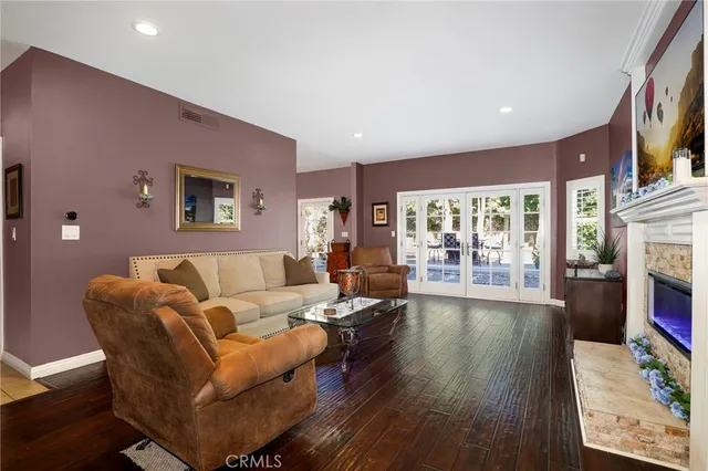 a living room with fireplace furniture and a flat screen tv