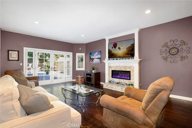 a living room with furniture a fireplace and a flat screen tv
