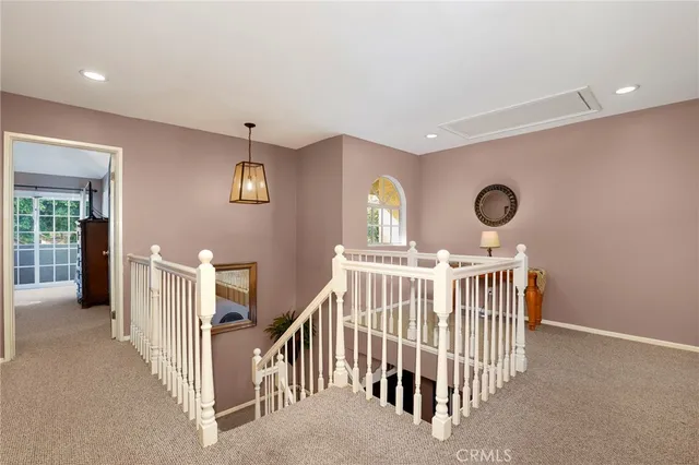 a view of a hallway with windows and stairs