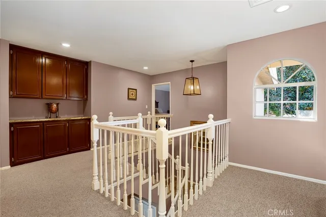a spacious bedroom with a bed and a chandelier