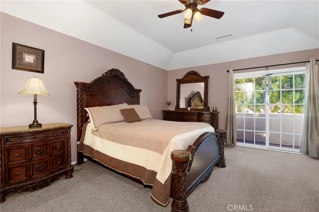 a bedroom with a bed and ceiling fan