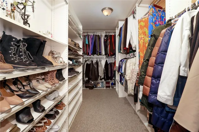 a bedroom with a bed and a flat tv screen on dresser