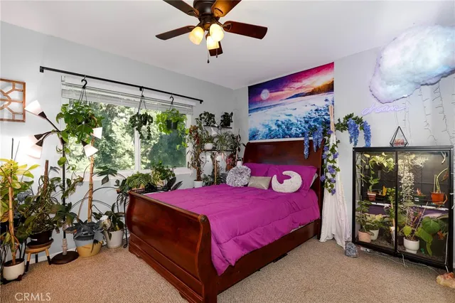 a bedroom with a bed dresser and a window