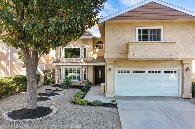 an aerial view of a house with a yard and wooden fence