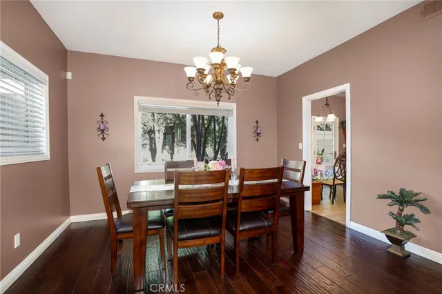 a view of a dining room with furniture wooden floor and chandelier