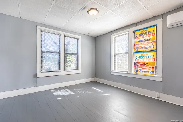 an empty room with windows and closet