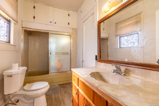 a bathroom with a sink toilet and shower