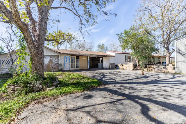 a view of a house with a yard and tree s
