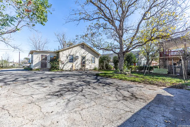 a view of a yard with a large tree