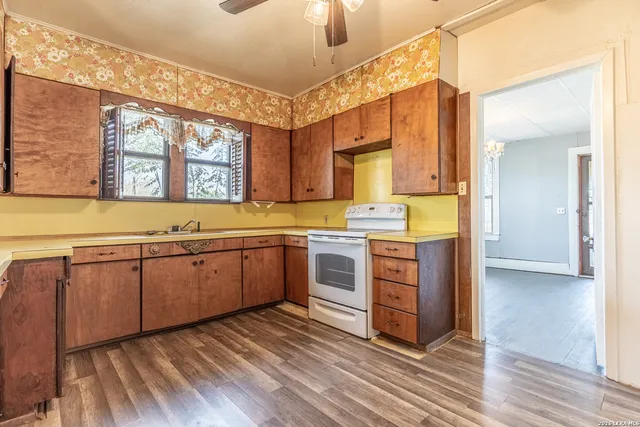 a kitchen with stainless steel appliances sink and cabinets