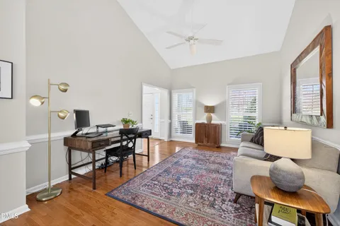 a bedroom with a bed and walk in closet with wooden floor