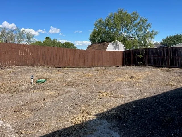 a backyard of house with wooden fence
